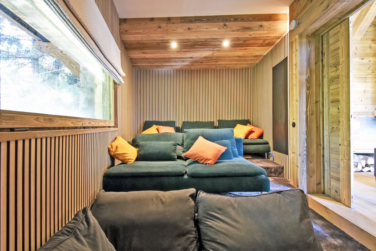 A living room with a green couch and yellow pillows