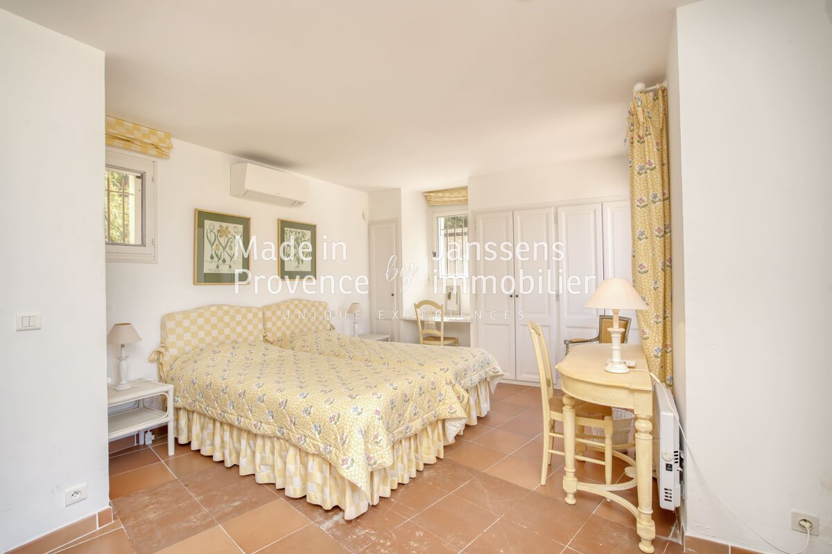 A bedroom with two beds and a desk that says made in provence