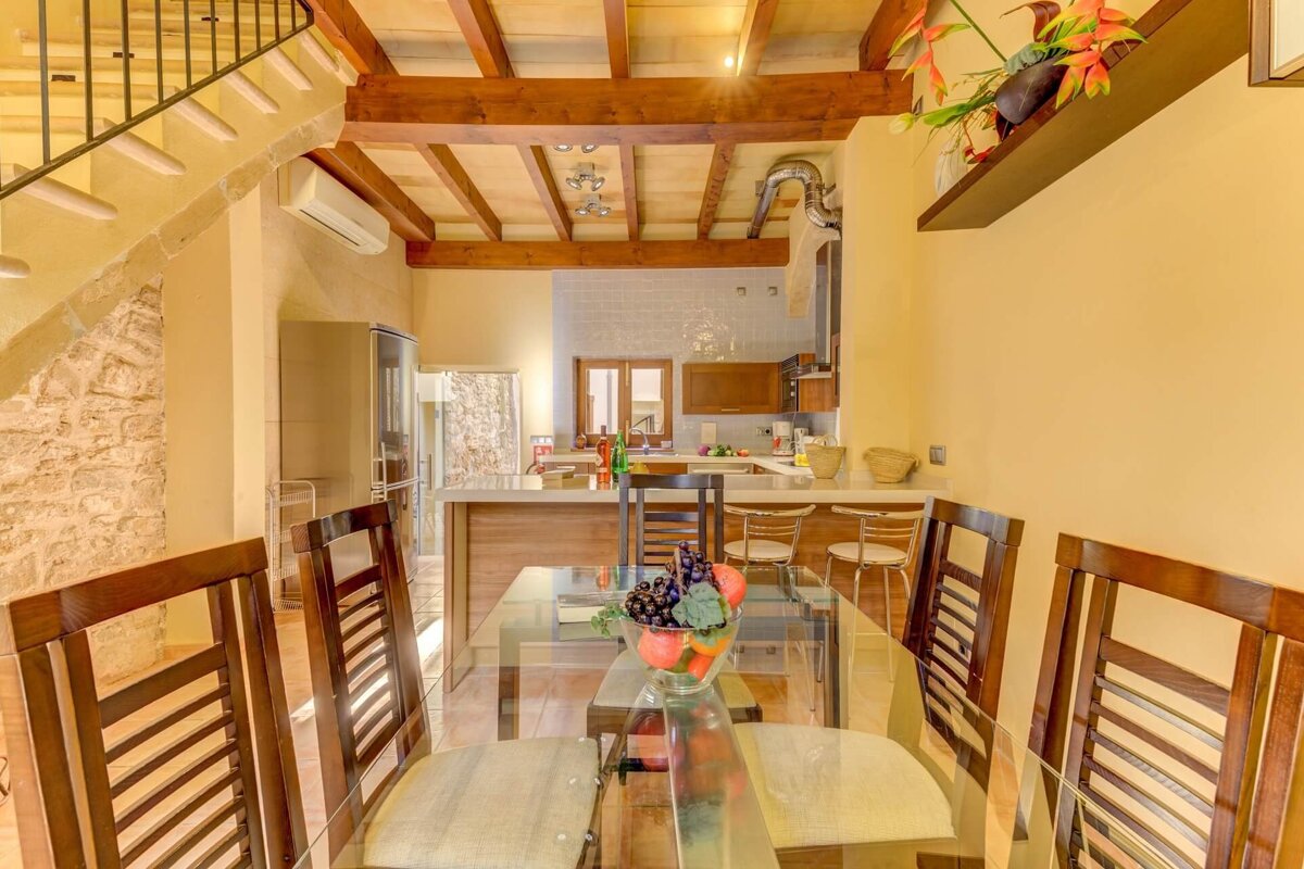 A dining room table with a bowl of grapes on it