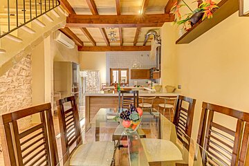 A dining room table with a bowl of grapes on it