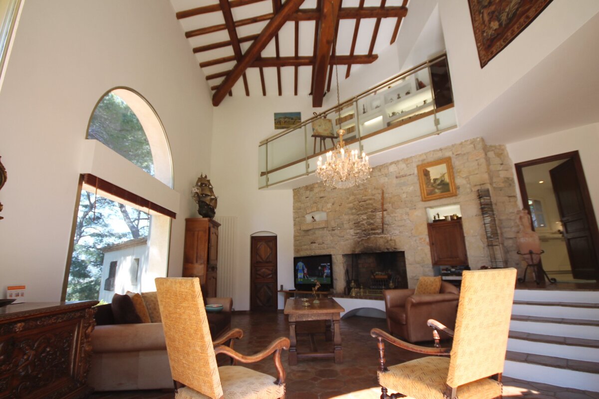 A living room with a fireplace and a chandelier