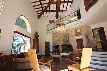 A living room with a fireplace and a chandelier