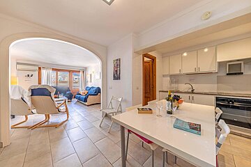 A living room with a dining table and chairs