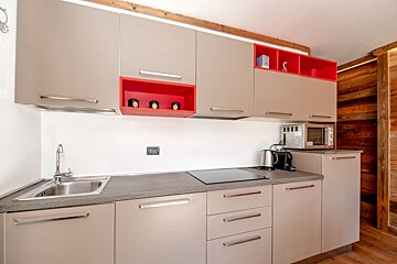 A kitchen with a stove top oven and a sink