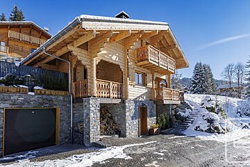 A large wooden house with stairs leading up to it