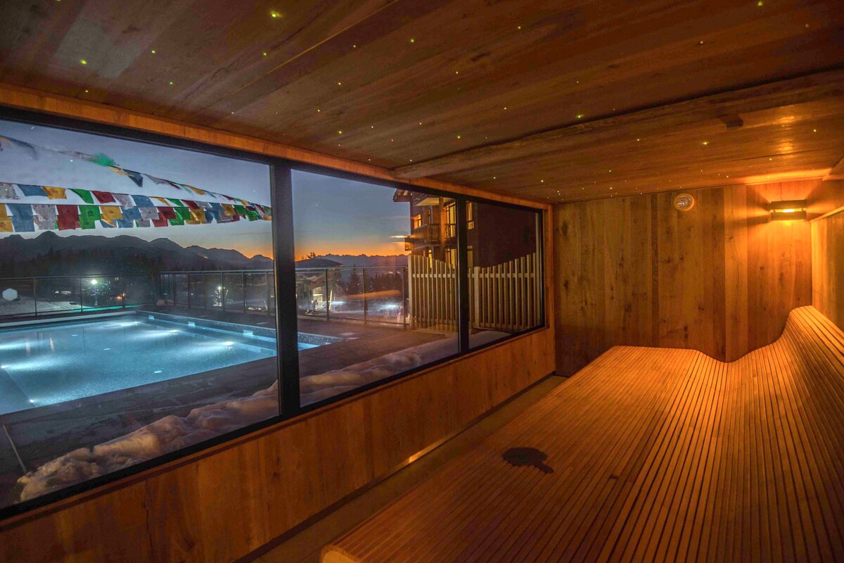 A wooden room with a view of a swimming pool
