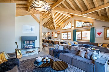 A living room with a large couch and a fireplace