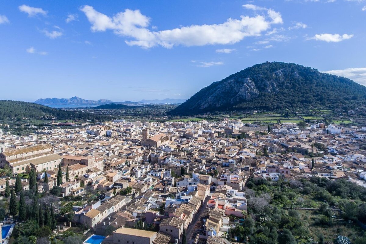 An aerial view of a small town with mountains in the background