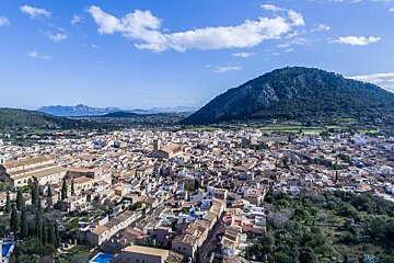 An aerial view of a small town with mountains in the background