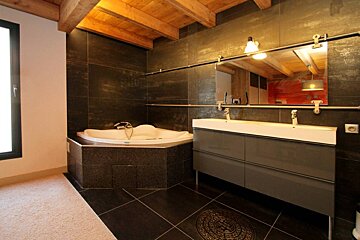 A bathroom with two sinks and a jacuzzi tub