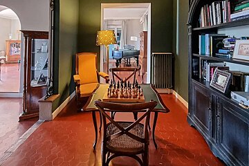 A chess board sits on a table in a library
