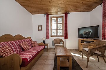 A living room with a couch and a flat screen tv