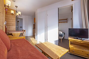 A living room with a couch and a flat screen tv