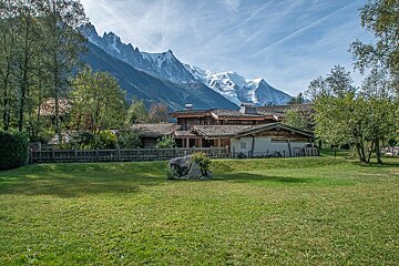 A large house with a mountain in the background