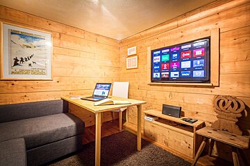 A living room with a couch and a flat screen tv