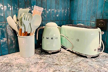 A smeg kettle and toaster are on a counter