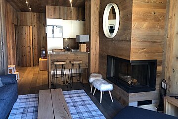 A living room with a fireplace and a mirror on the wall