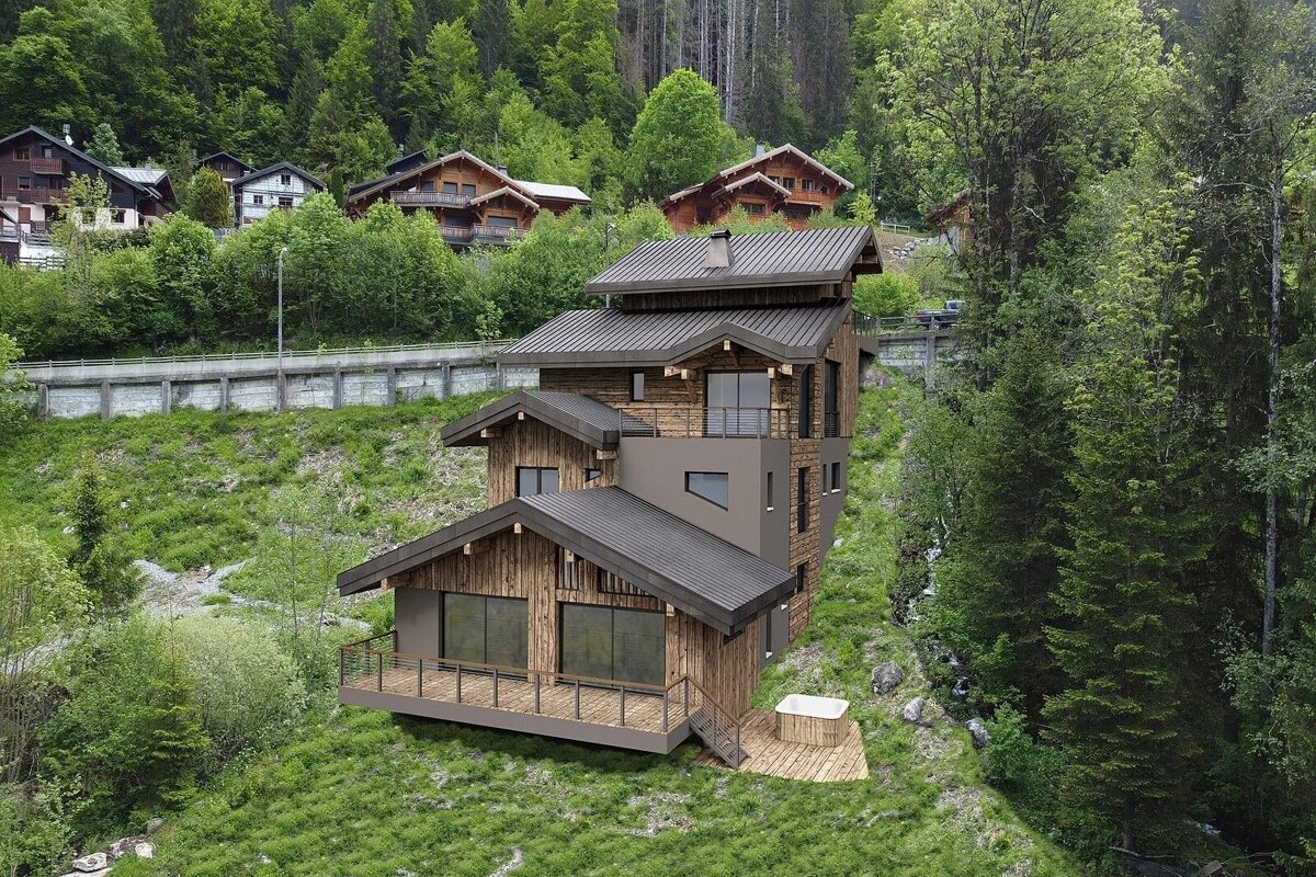 Modern multi-level wooden chalet on a grassy mountain slope, surrounded by lush forests and other alpine cabins.