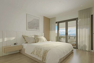 A bedroom with a large bed and a sliding glass door