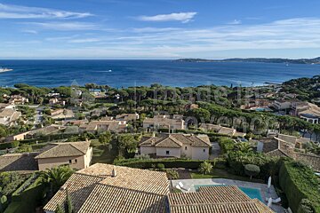 An aerial view of a residential area with a large body of water in the background
