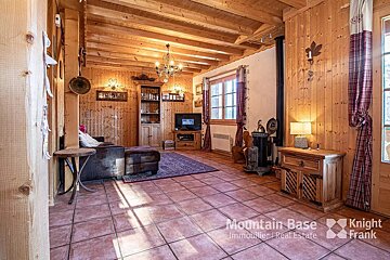 A living room with wood paneling and a sign that says mountain base