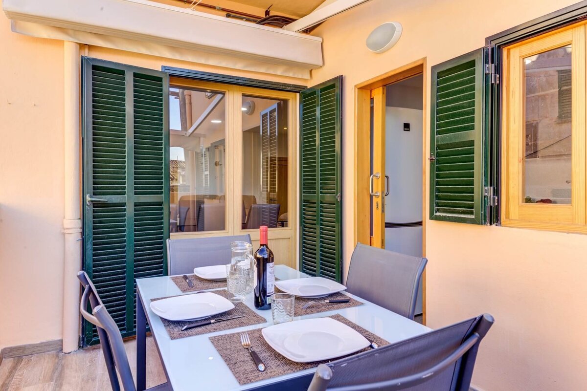 A table with plates and a bottle of wine on it