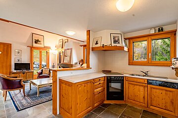 A kitchen with wooden cabinets and a dishwasher
