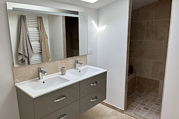 A bathroom with two sinks and a mirror