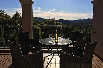 A table with wine glasses and a bottle of wine on it