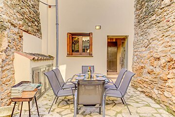A table with plates and a bottle of wine on it