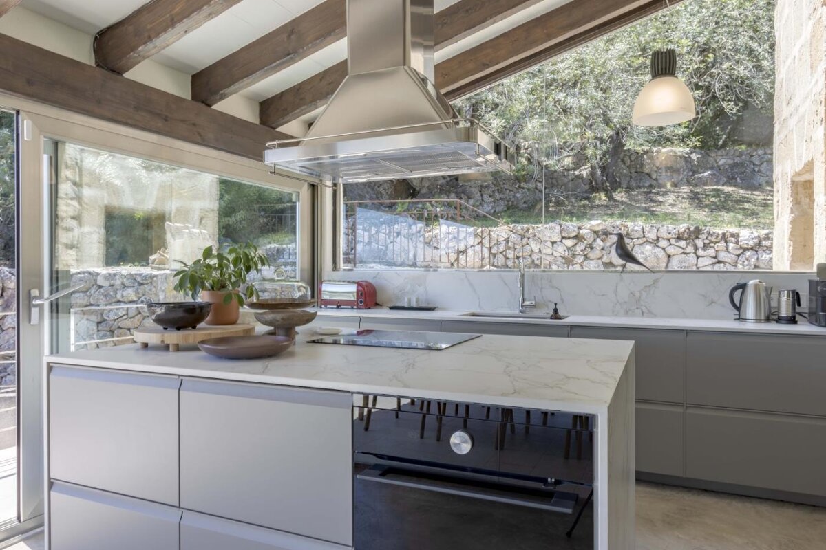 A kitchen with a large island and a stove top oven