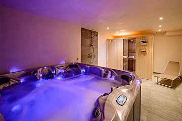 A hot tub in a room with a blue light on it