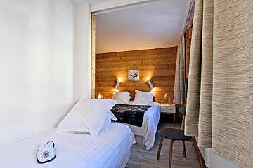 A bedroom with a bed and a picture on the wall