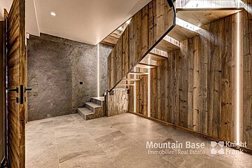 A hallway with a staircase and a sign that says mountain base