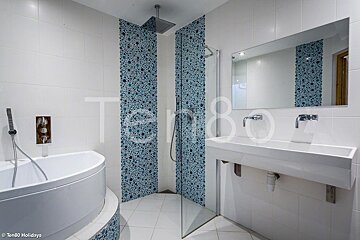 A bathroom with blue and white tiles and the word tempo on the bottom