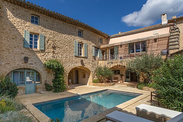 A large stone building with a swimming pool in front of it