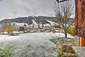 A snowy landscape with a mountain in the background