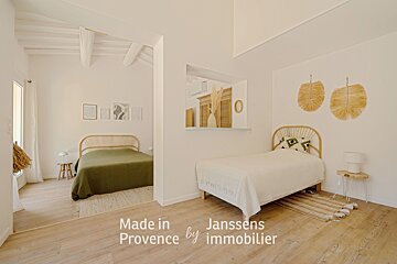 A bedroom with the words made in provence by immobilier on the bottom