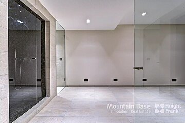 An empty room with a sign that says mountain base knight frank