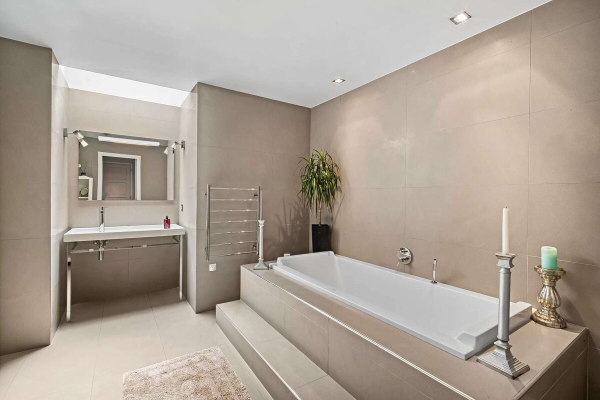 A bathroom with a large bathtub and a sink