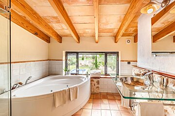 A bathroom with a jacuzzi tub and a sink
