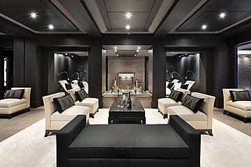 A living room with black and white furniture and a fireplace