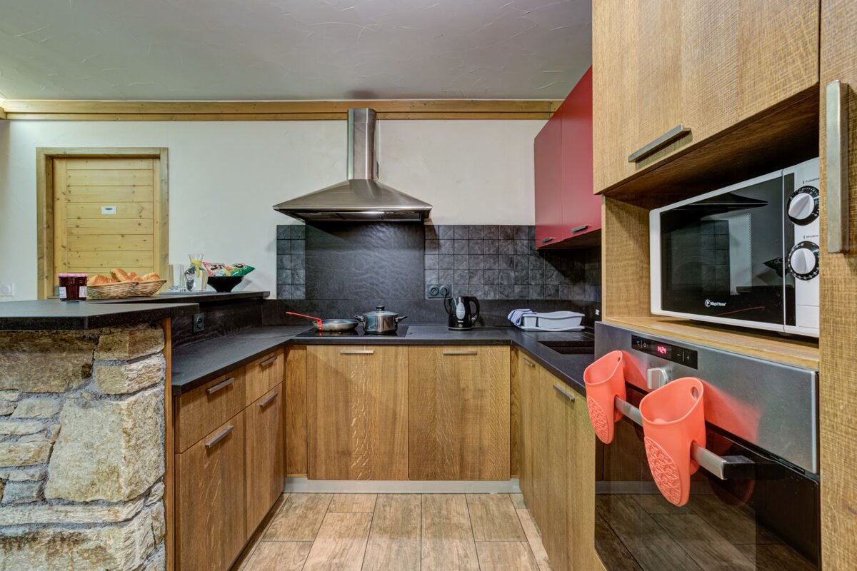 A kitchen with wooden cabinets and a microwave that says ' bosch ' on it