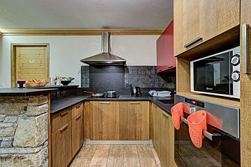 A kitchen with wooden cabinets and a microwave that says ' bosch ' on it