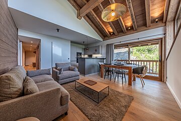 A living room with a couch a chair and a table