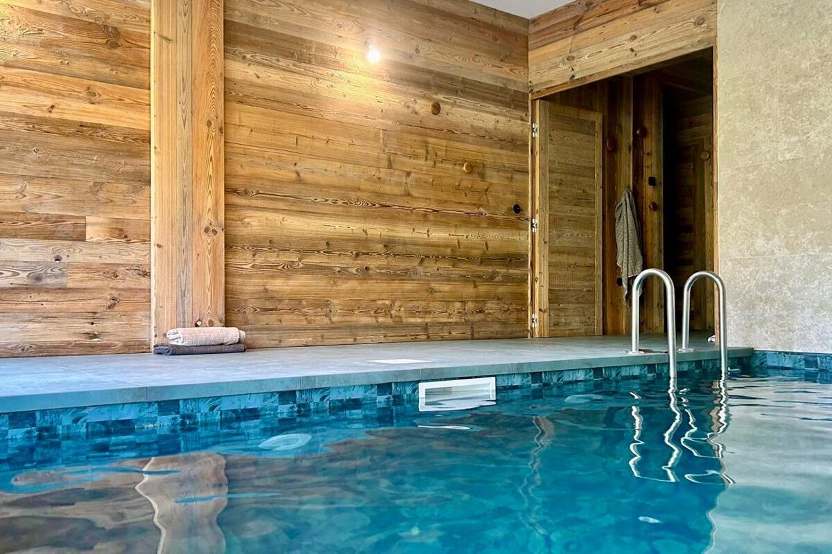 A swimming pool with a wooden wall behind it