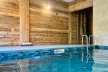 A swimming pool with a wooden wall behind it