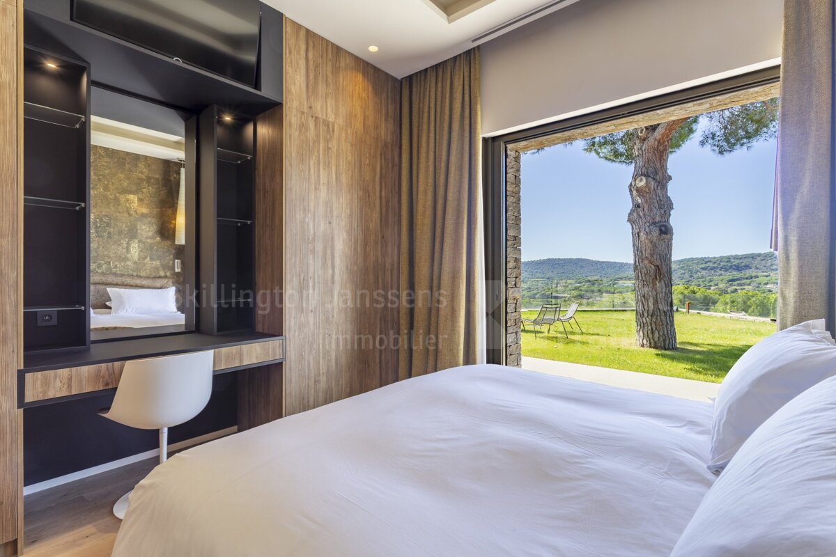 A bedroom with a sliding glass door that says killington janssens immobilier
