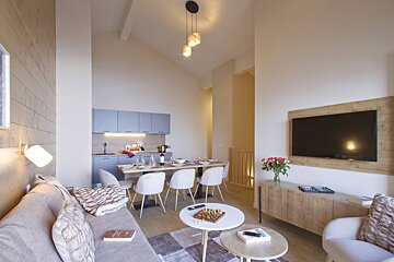 A living room with a couch a table and a television