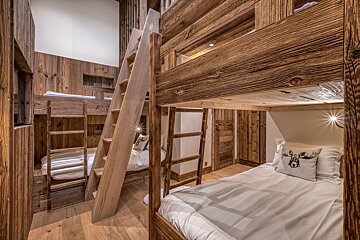 A bunk bed with a moose pillow on it